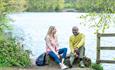 two people sitting on  rock beside Knypersley Pool